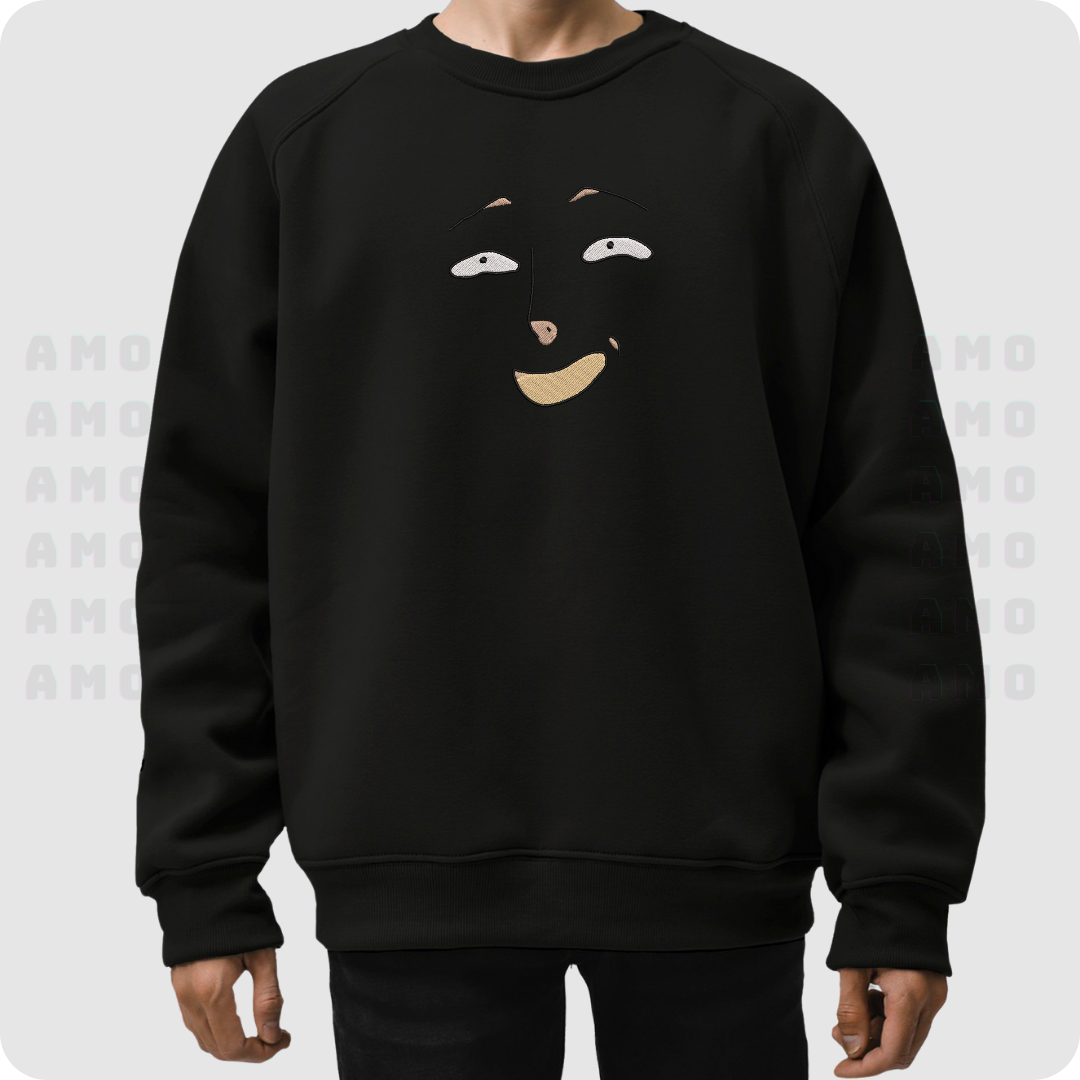 Black embroidered sweater worn by model with cheerful face design on chest