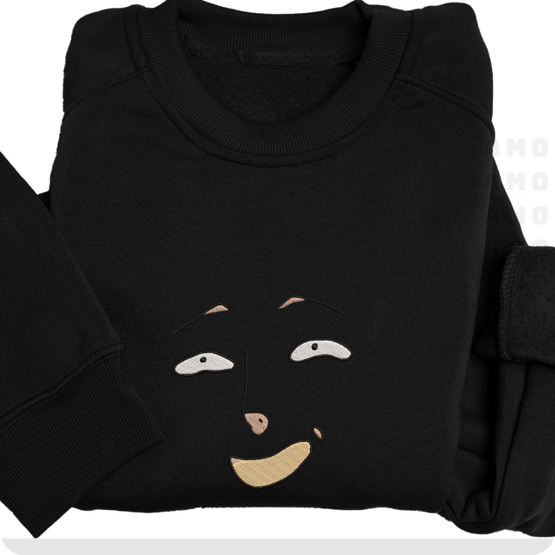 Flat lay of black embroidered sweater showing front with smiling face motif