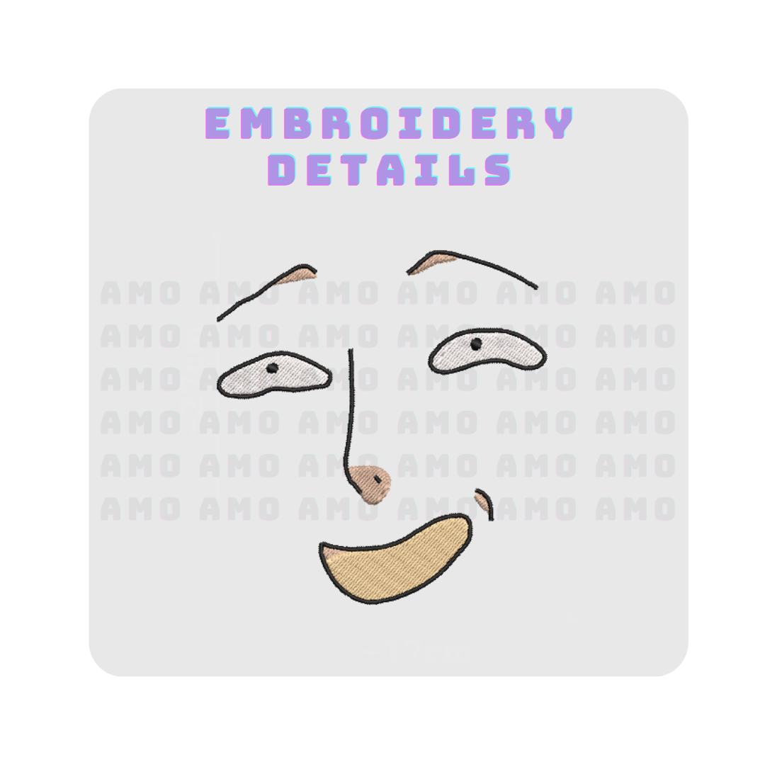 Embroidery design close-up showing stitched facial features with tan and white thread