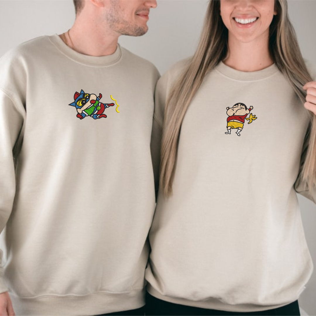 Beige embroidered sweatshirt with ShinChan designs on front, couple model wearing together