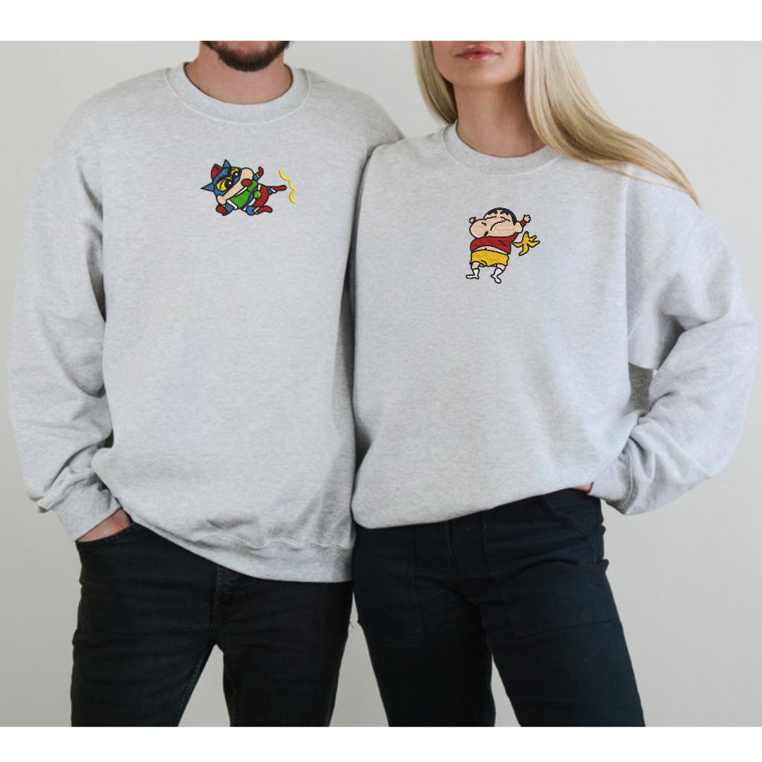 Light gray embroidered sweatshirt with colorful ShinChan and playful character design worn by couple