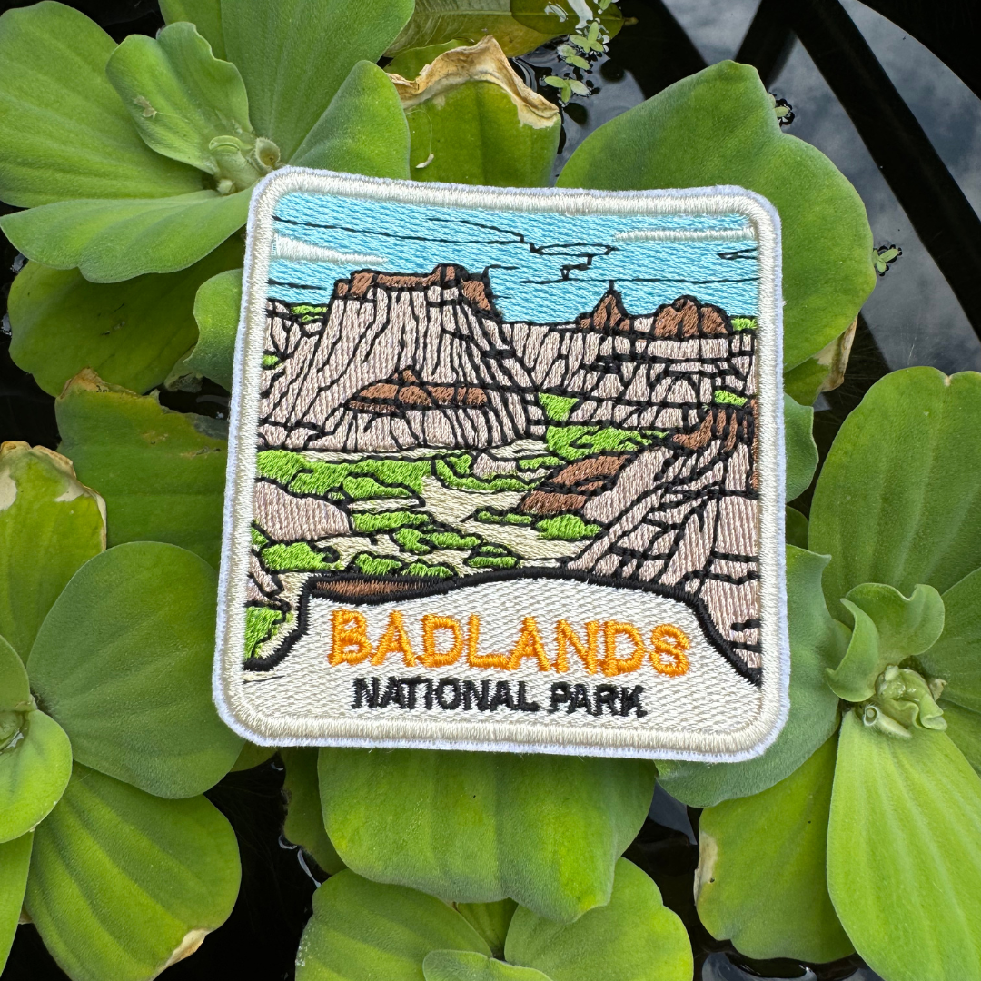 Hiking souvenir patch on green water lettuce leaves
