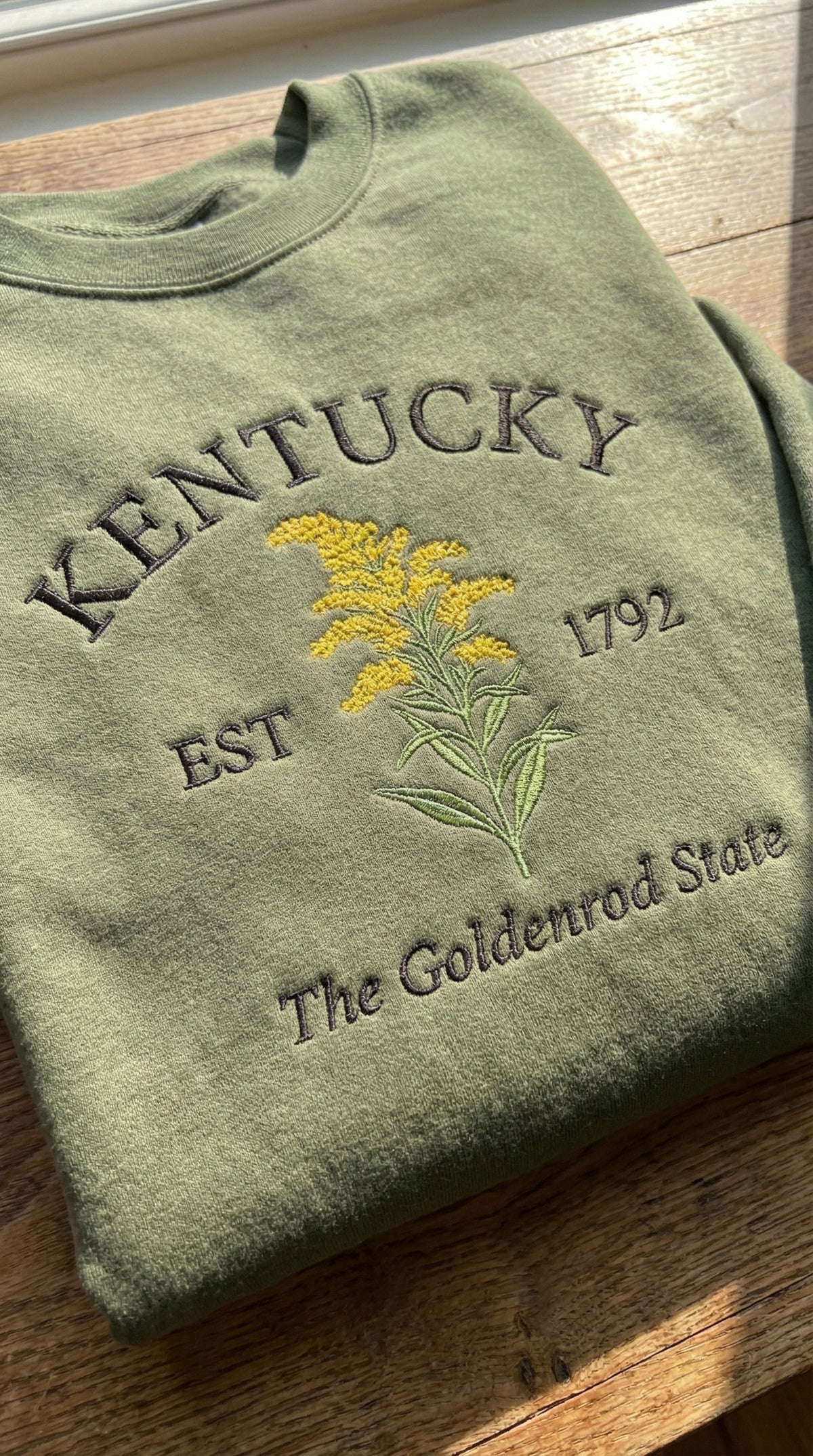 Close-up goldenrod flower embroidery Kentucky sweatshirt detail