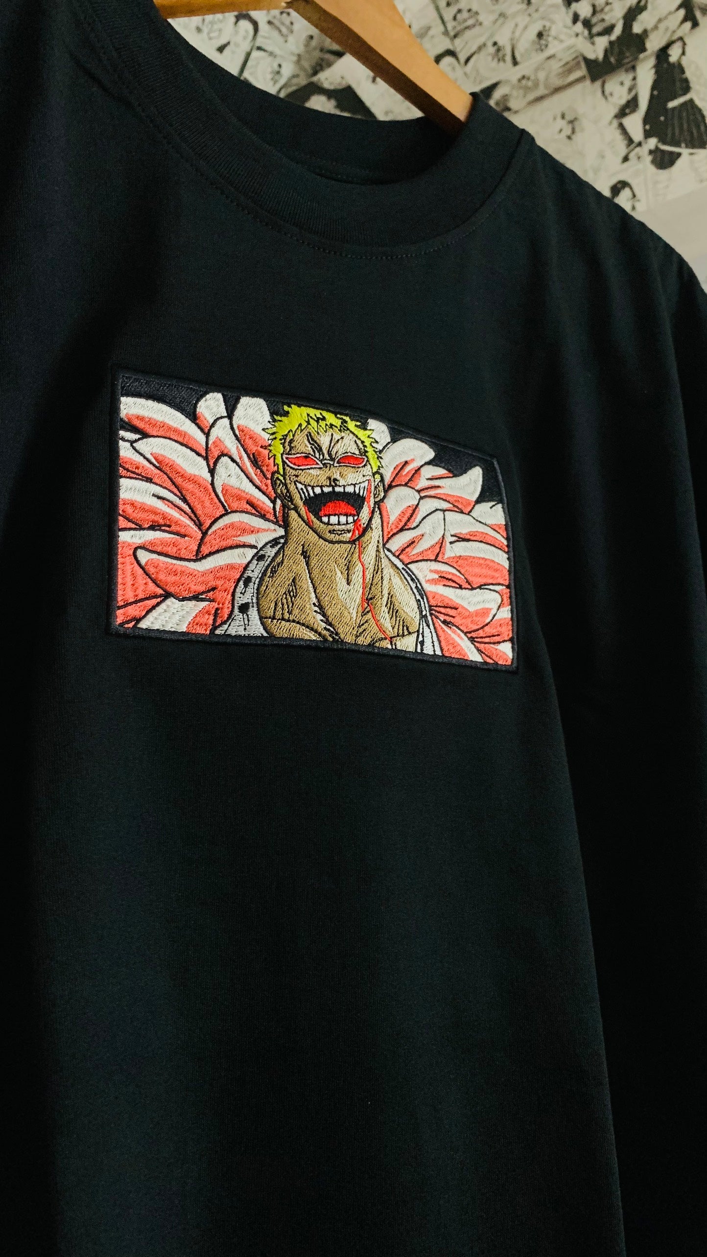 Close-up of Doflamingo grin embroidery on t-shirt