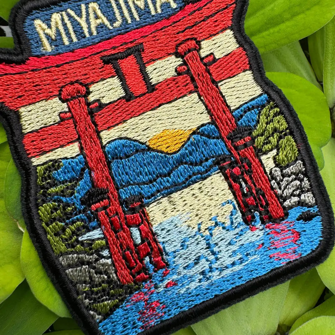 Colorful Japanese souvenir patch with mountains and water reflection