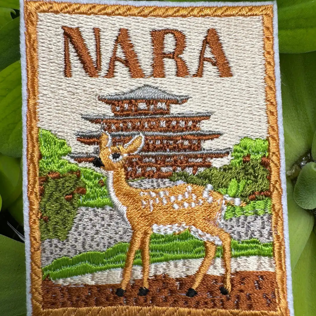 Close-up of Nara Japan badge with temple and deer design