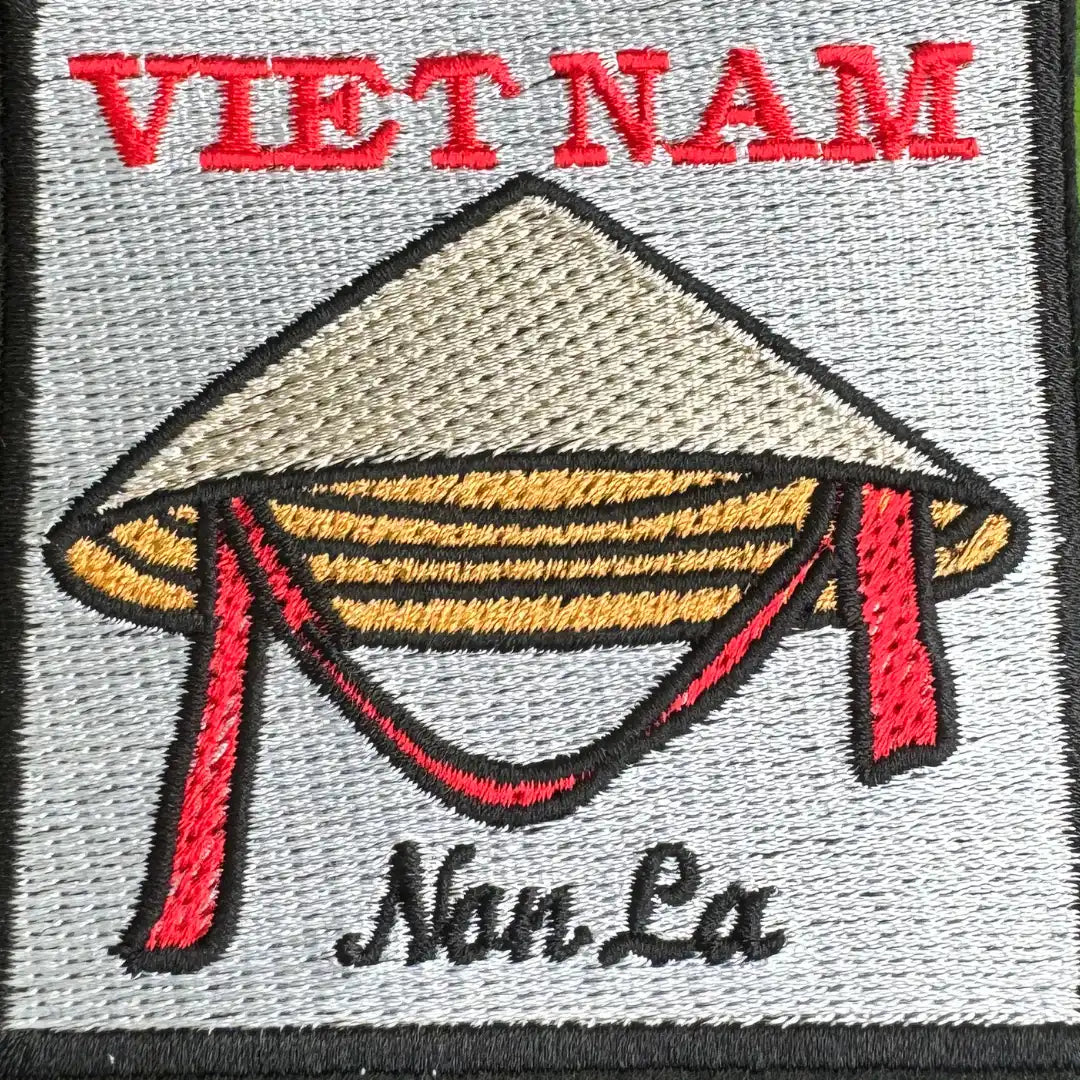 Close-up of Vietnamese conical hat embroidery on gray background