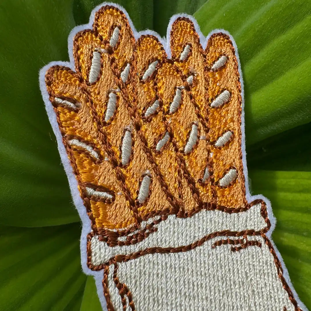 Iron-on baguette patch on leafy background