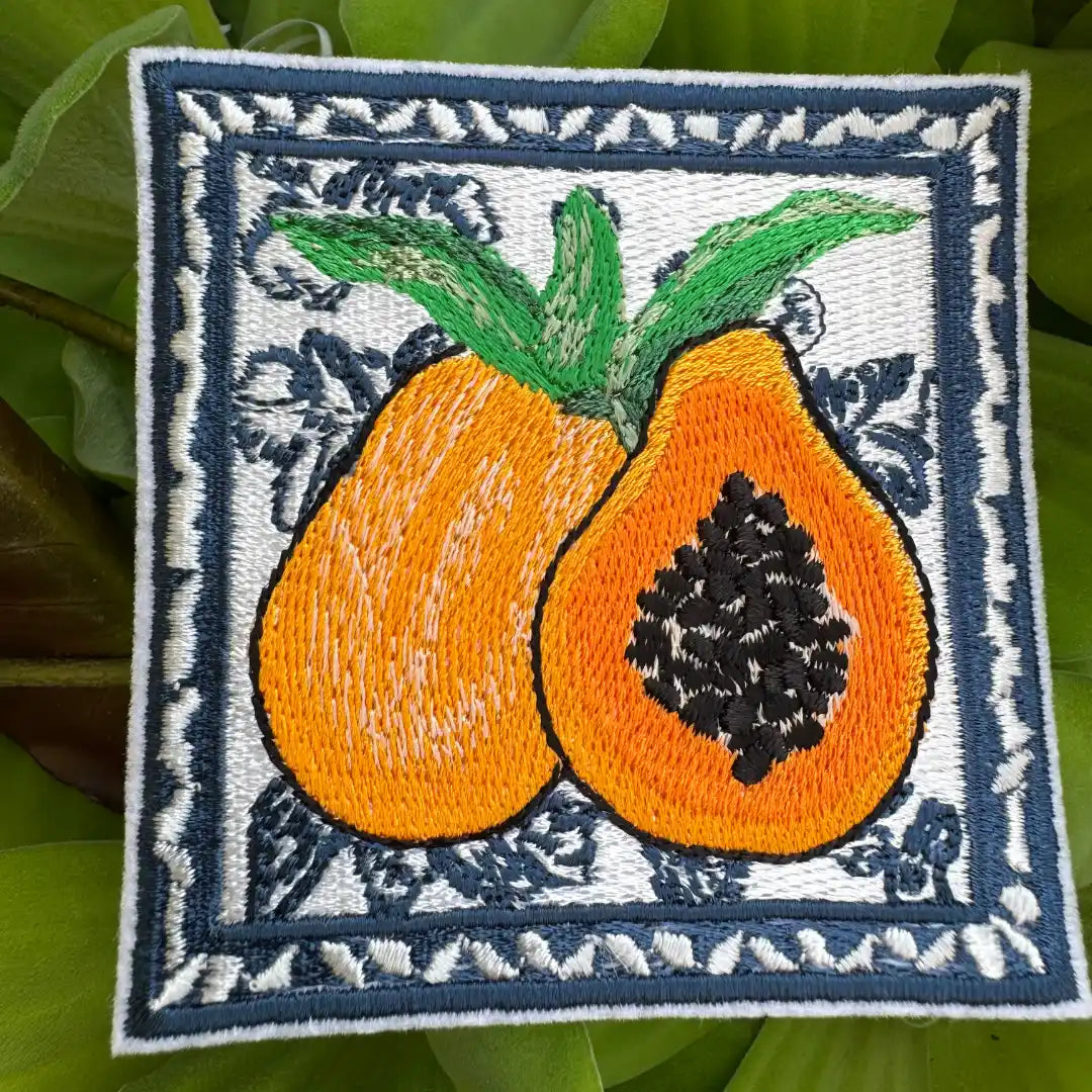 Close-up of tropical papaya embroidery on square pat