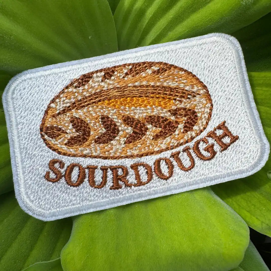 Sourdough patch on green leaves background