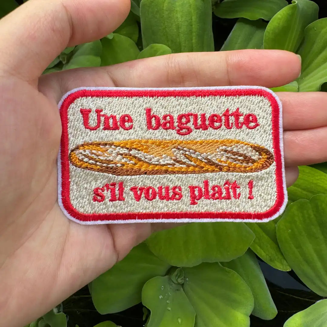 French baguette embroidered patch held in hand