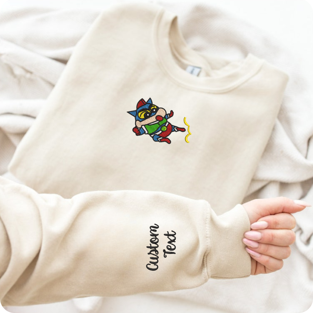 Cream embroidered sweatshirt with cheerful ShinChan character and custom text on sleeve