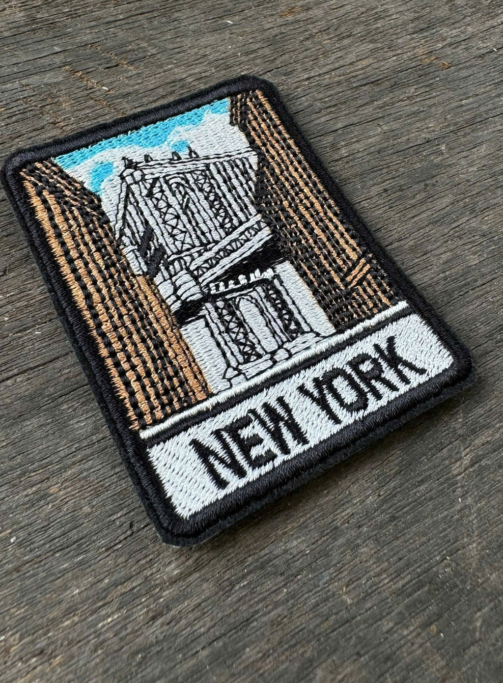 New York embroidery patch featuring suspension bridge and city buildings
