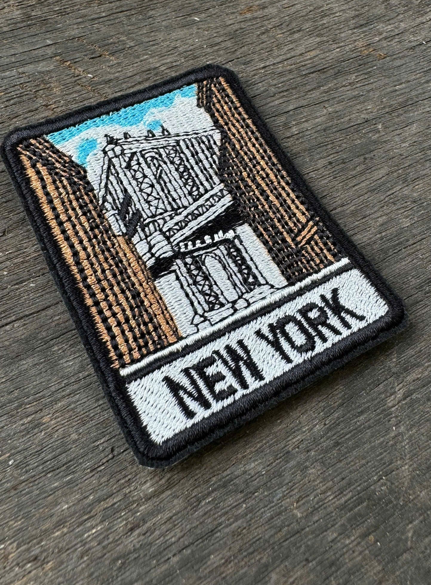 New York embroidery patch featuring suspension bridge and city buildings