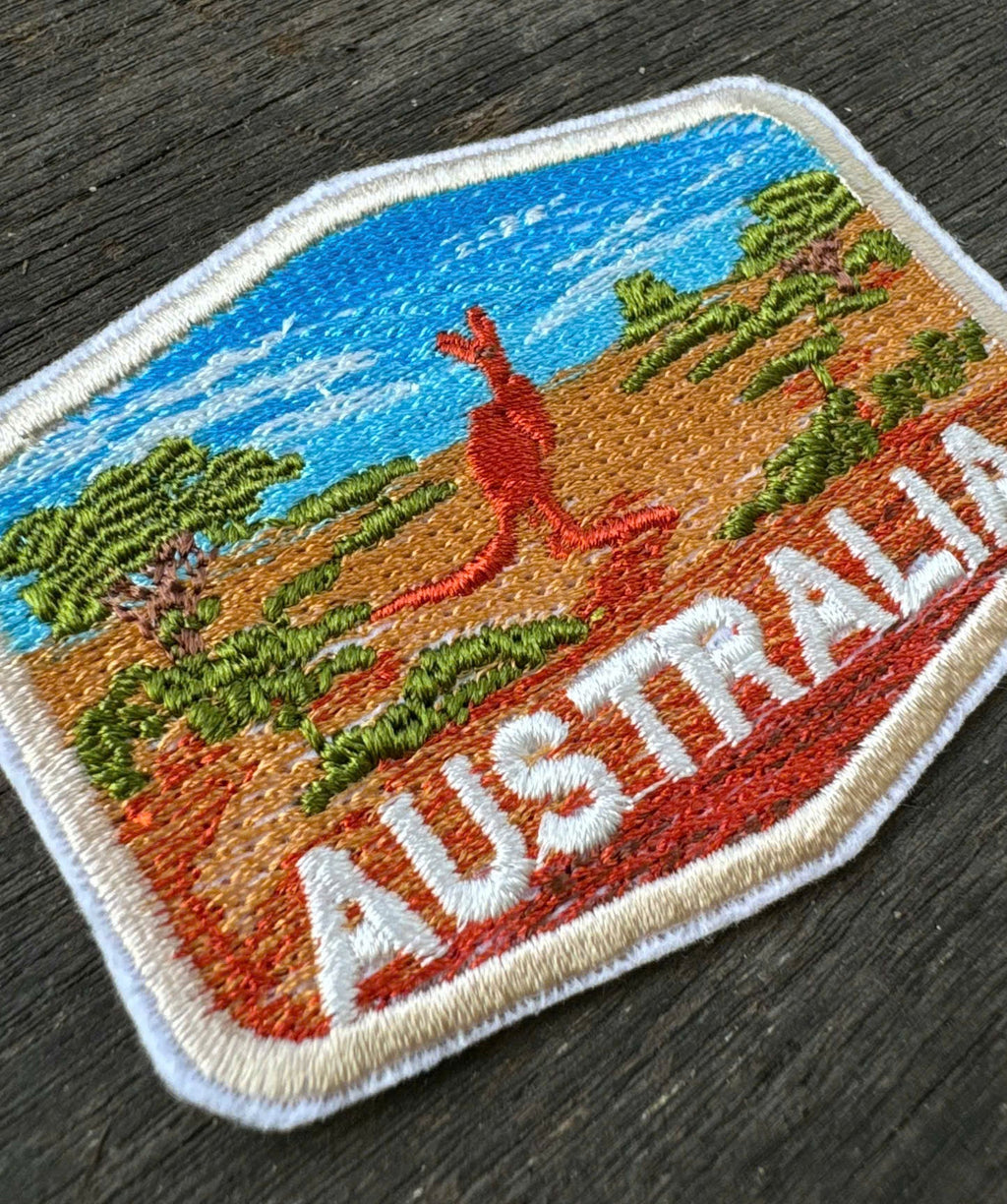 Embroidered patch with kangaroo and 'Australia' text on a wooden surface