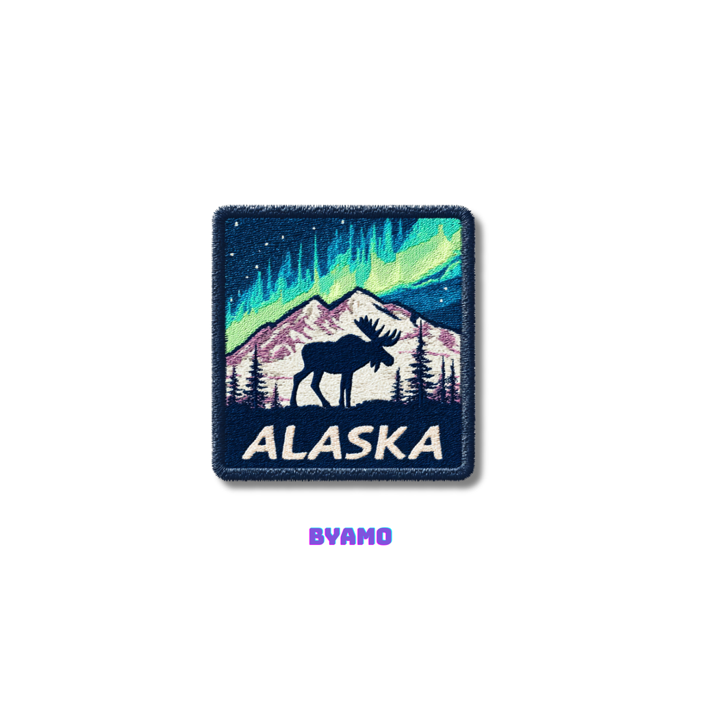Patch with moose and Northern Lights design on a blue background, featuring the word 'Alaska' and the brand 'BYAMO'.