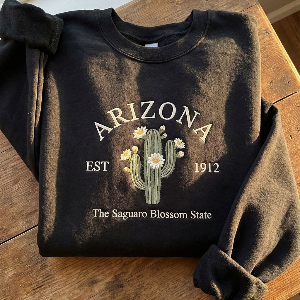 Charcoal black sweatshirt with detailed Saguaro cactus and white blossom embroidery reading Arizona EST 1912 The Saguaro Blossom State