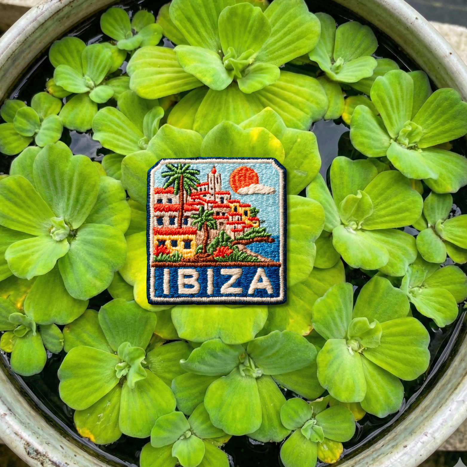 Close-up embroidery detail of Ibiza coastal village patch
