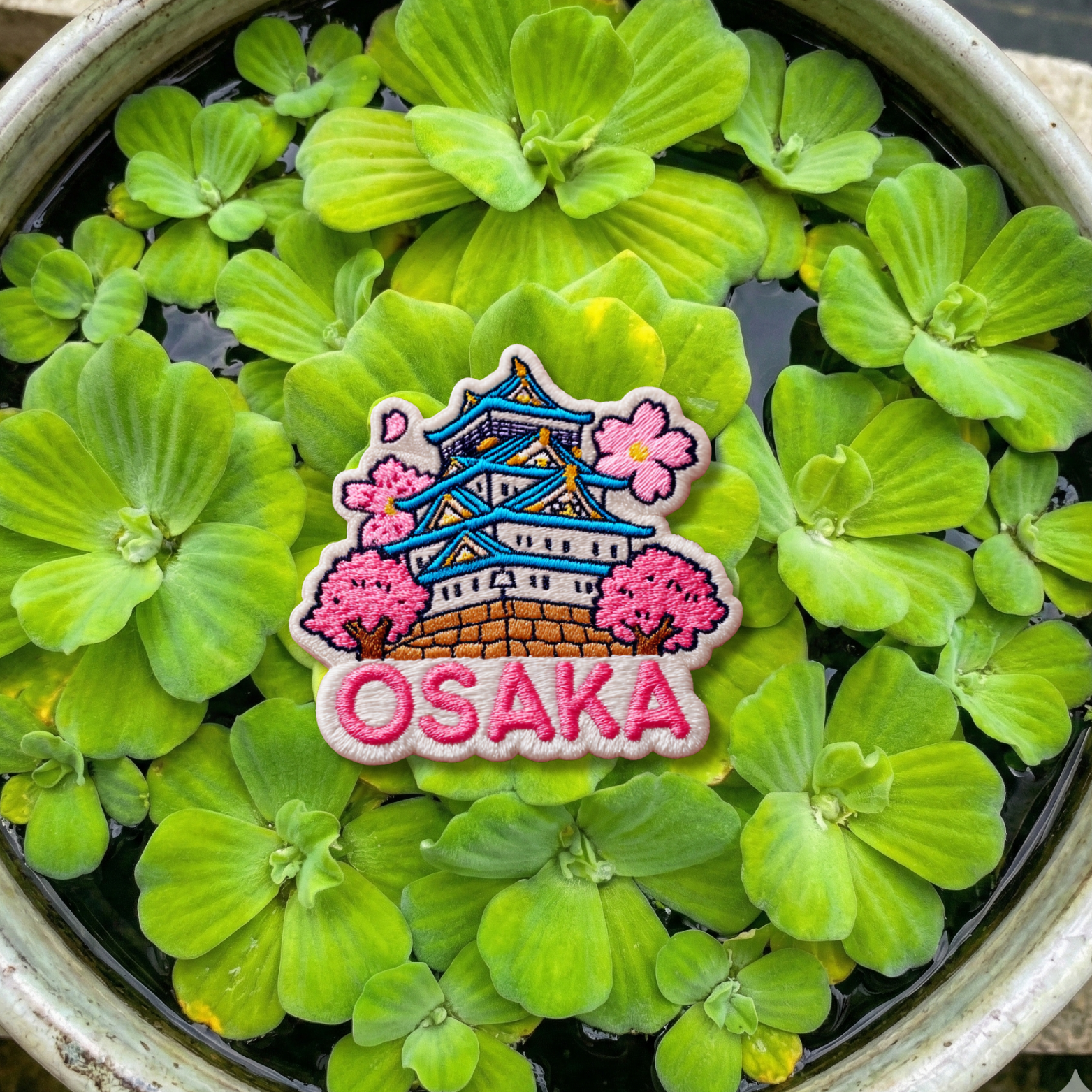Close-up embroidery details of Osaka Castle cherry blossom travel patch
