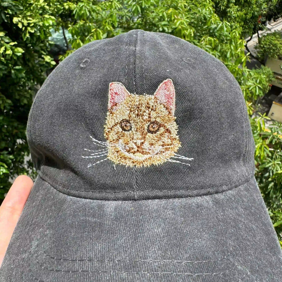 Close-up of realistic pet embroidery on adjustable dad hat