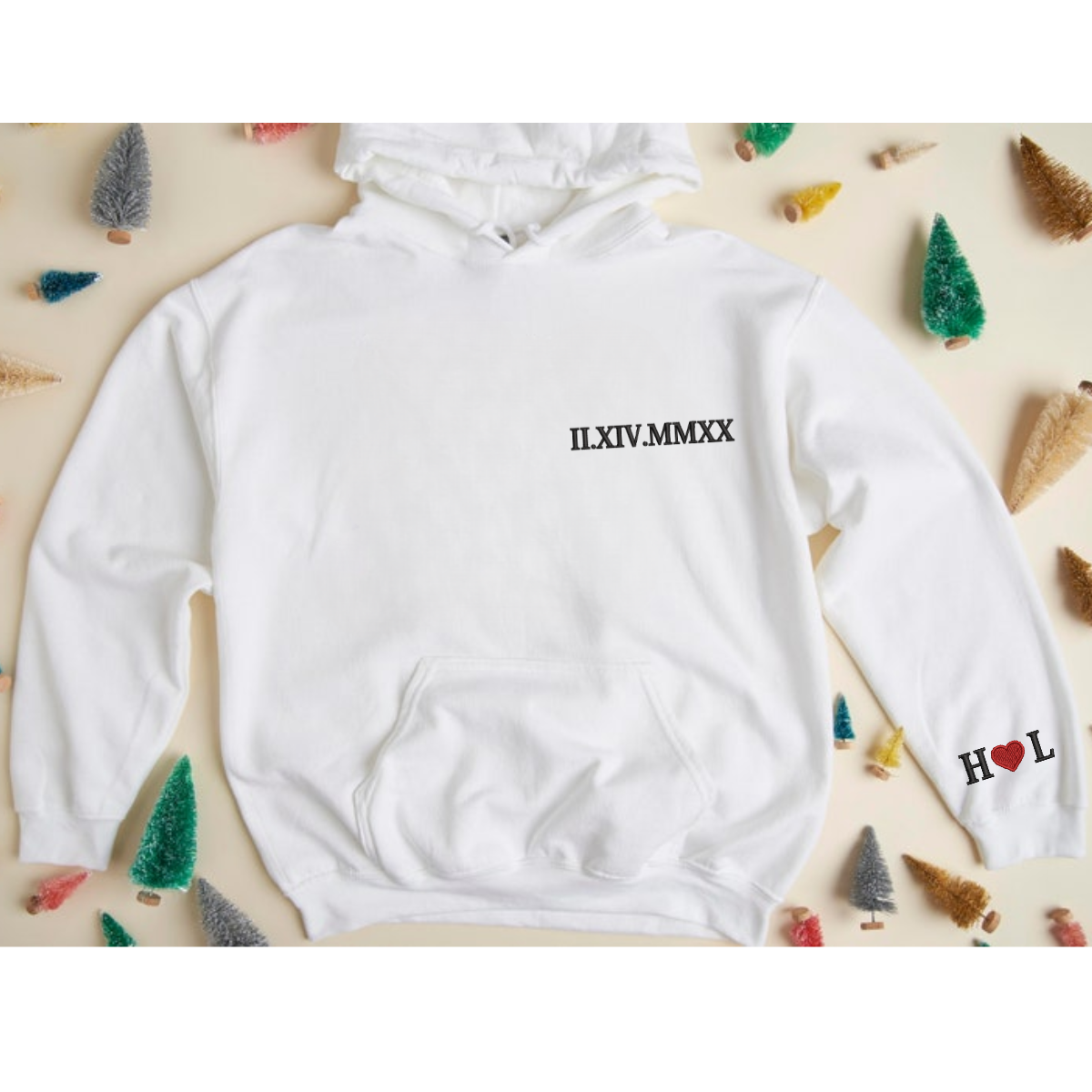 Close-up of white hoodie with Roman numeral embroidery