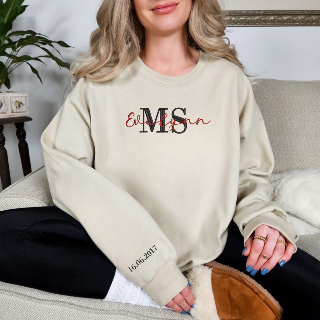 Custom Mrs embroidered sweatshirt folded neatly on bed