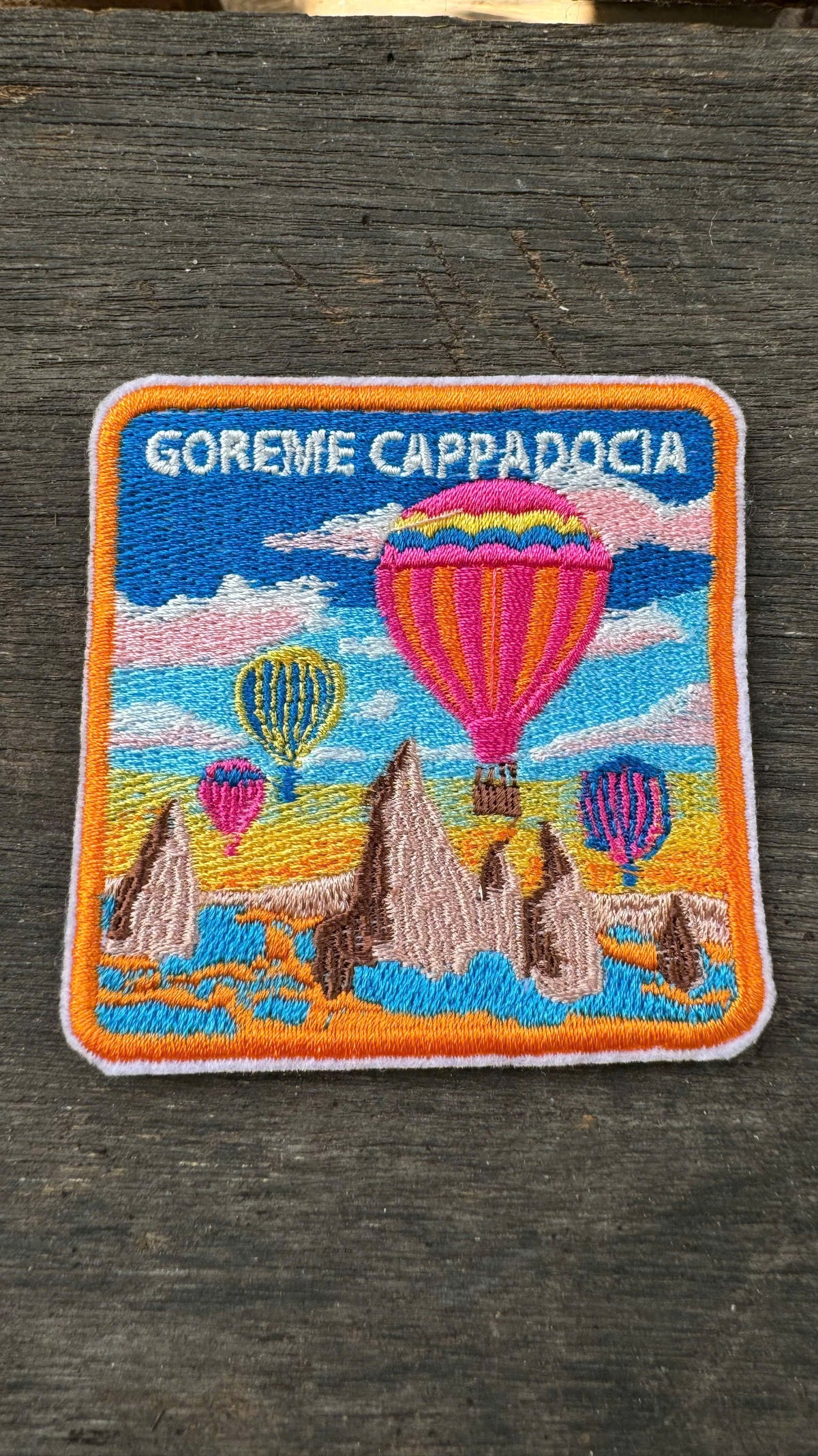 Embroidered patch of Goreme Cappadocia with hot air balloons on a wooden surface