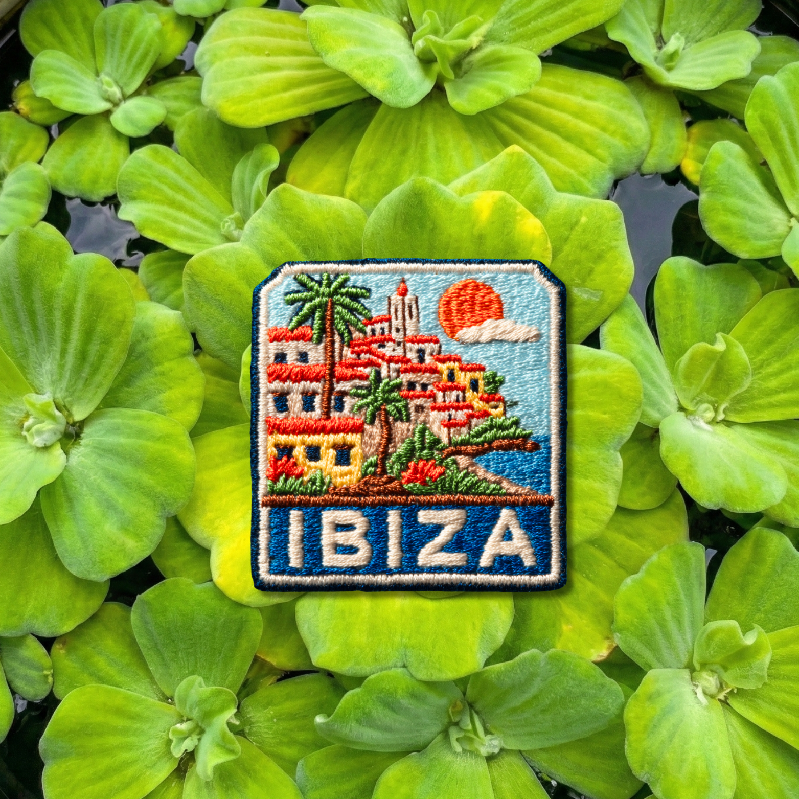 Ibiza embroidery patch with Mediterranean village, palm trees and sunset
