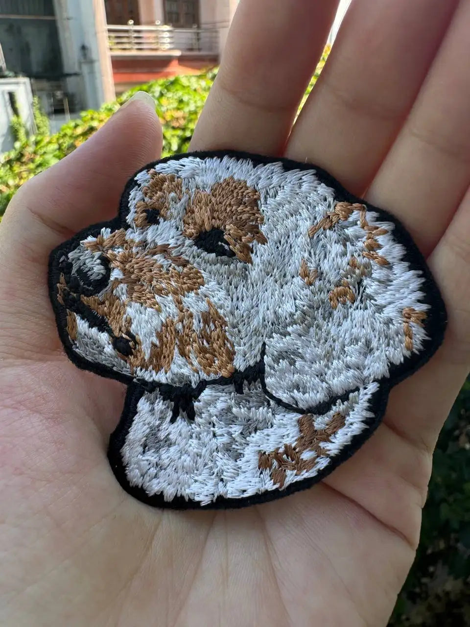 Iron-on Labradoodle dog patch on denim jacket