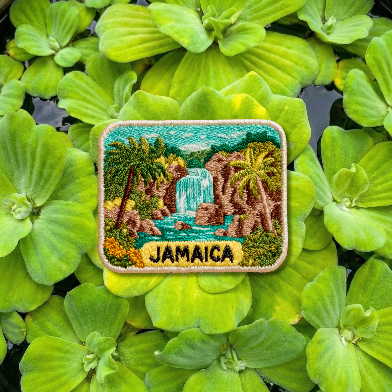 Jamaica embroidery patch featuring tropical waterfall and lush jungle landscape
