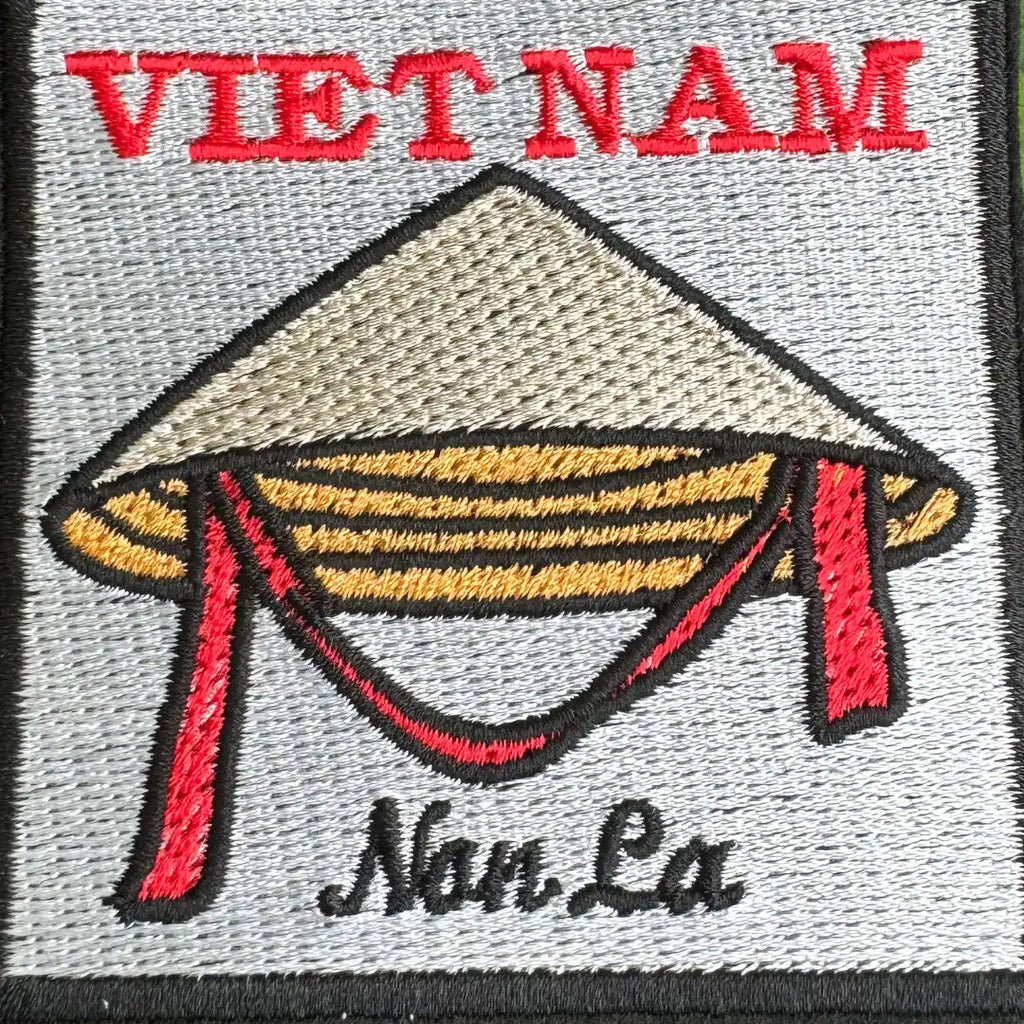 Close-up of Vietnamese conical hat embroidery on gray background