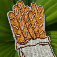 Iron-on baguette patch on leafy background