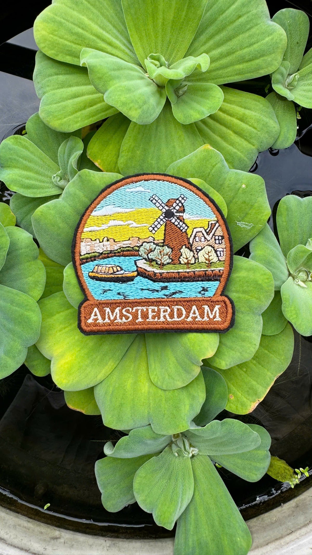 Patch with Amsterdam design on green leaves