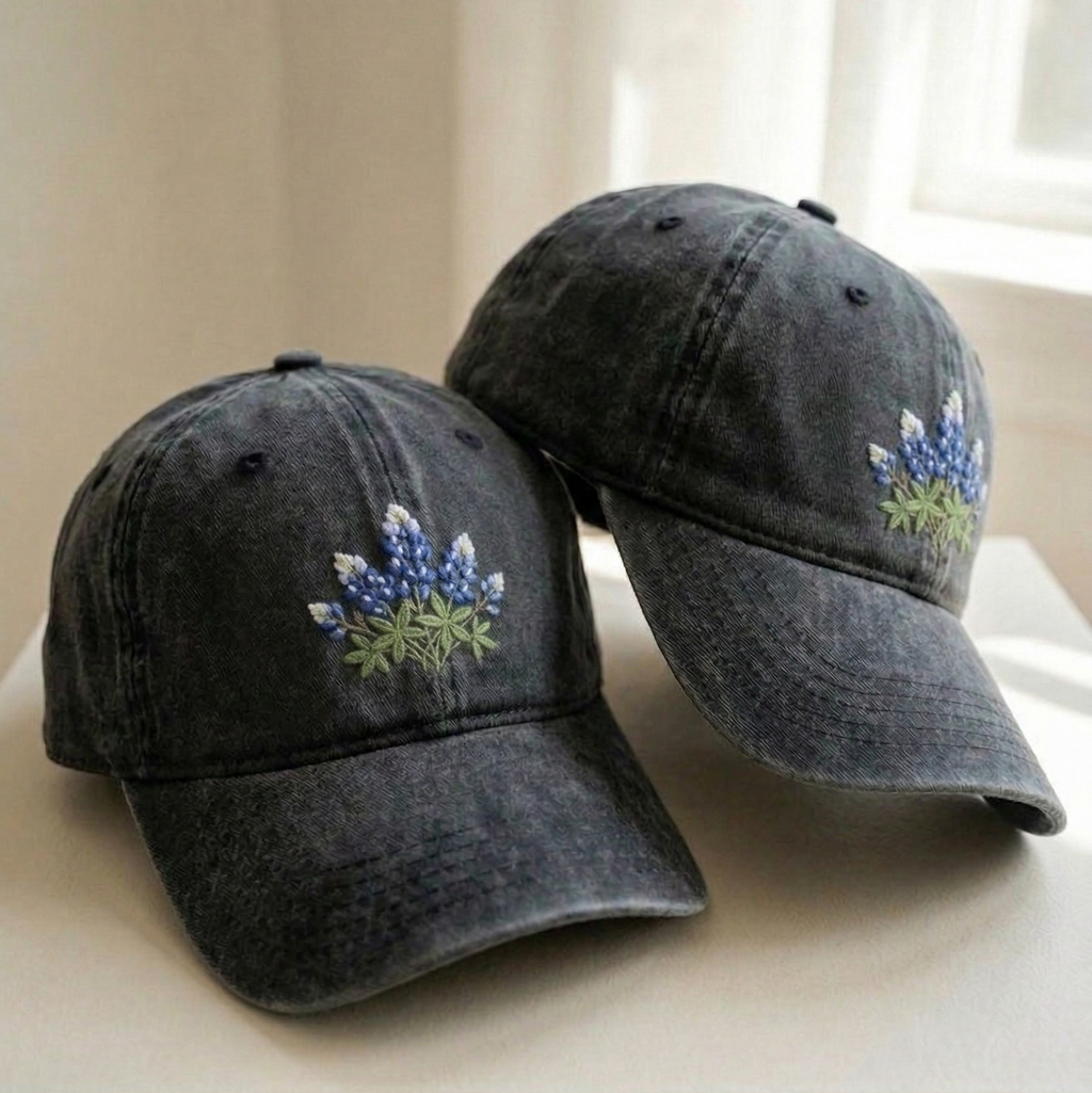 Woman wearing denim wildflower cap outdoors in a garden setting
