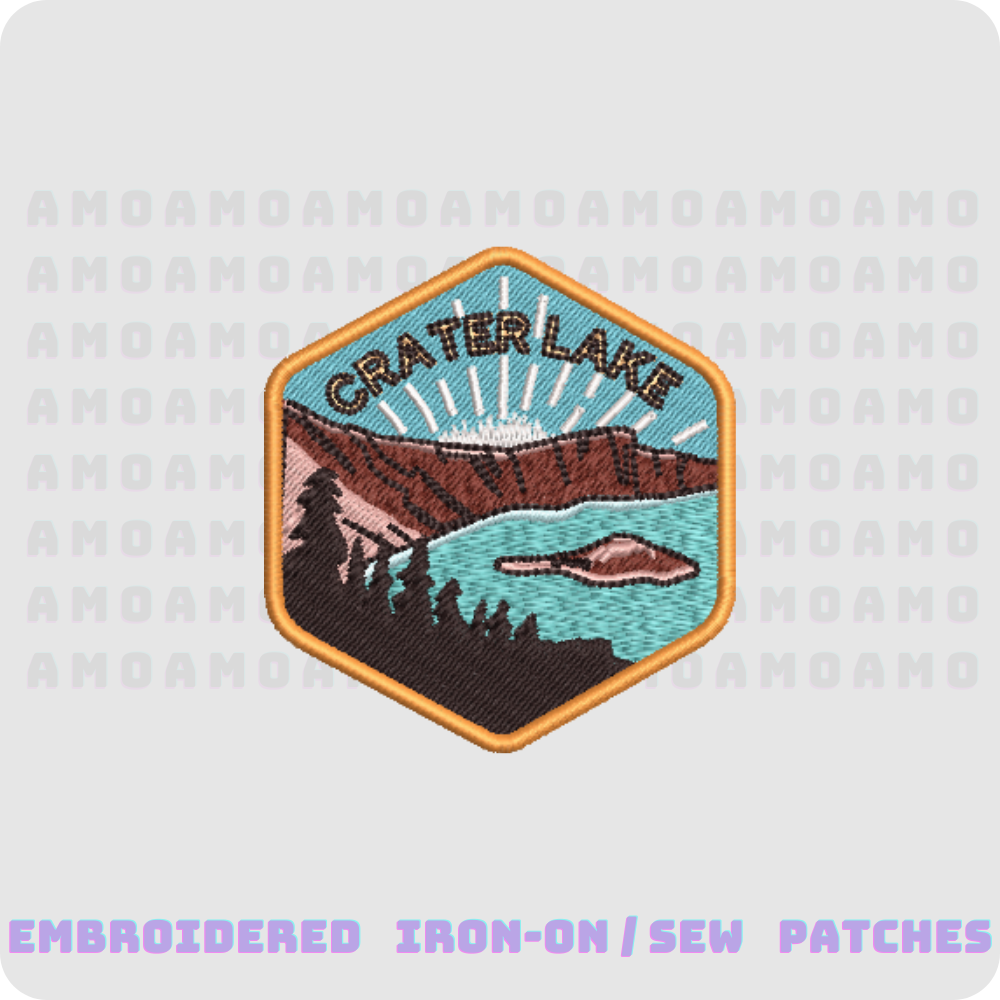 An embroidered patch featuring Crater Lake with a hexagonal shape, predominantly blue and brown in color, suitable for iron-on or sew-on applications.
